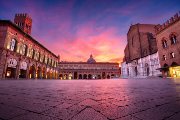 Cityscape image of old town Bologna, Italy with Piazza Maggiore at beautiful autumn sunrise.